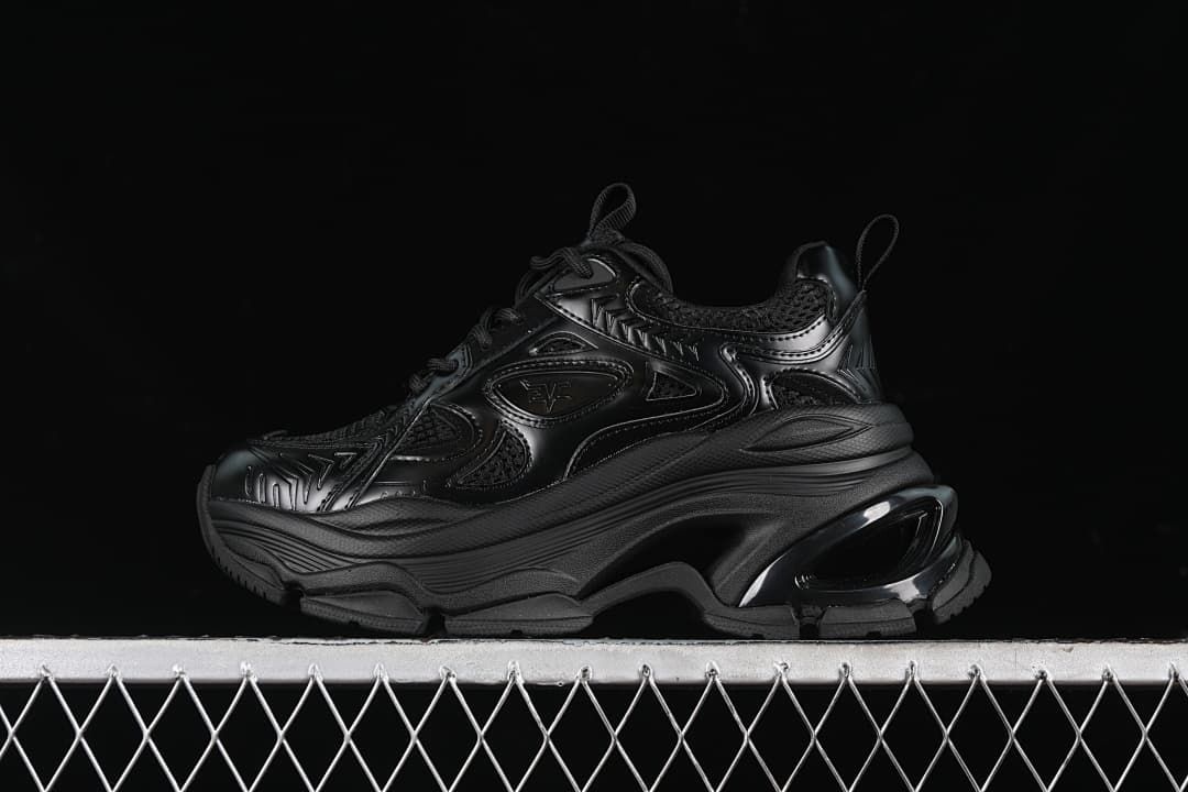 Side view of a black G24X9833 sneaker with a chunky platform-style sole.