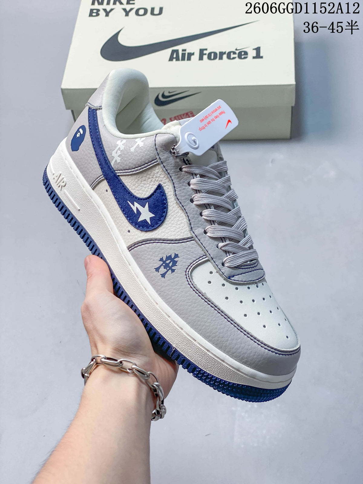 Angled view of the low-top sneaker with off-white, gray, and navy blue details