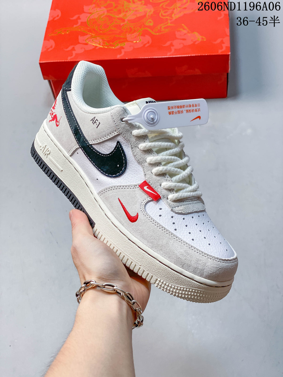 Angled side view showing the sneaker’s navy Swoosh, red accents, and heel graphic.