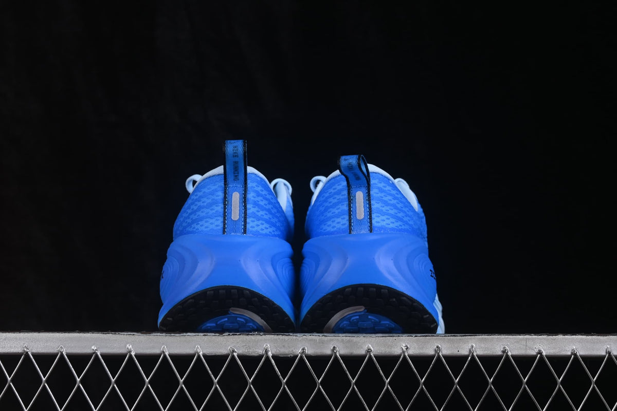Rear view showing blue heel panels, pull tabs, reflective-looking vertical details, and black outsole sections.