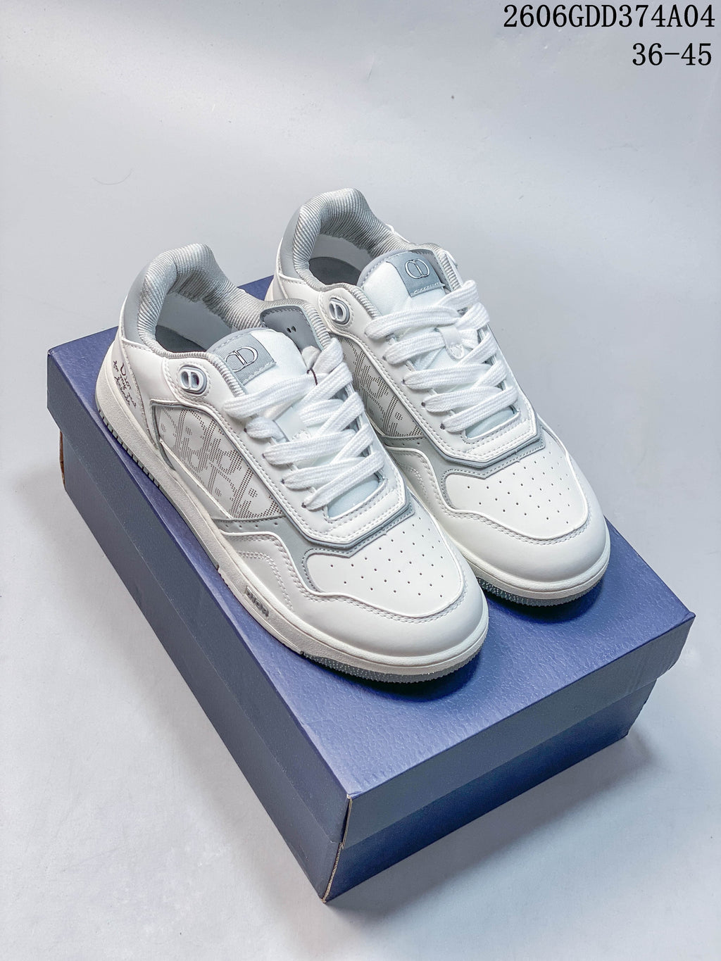 Pair of white and gray Dior low-top sneakers shown from above