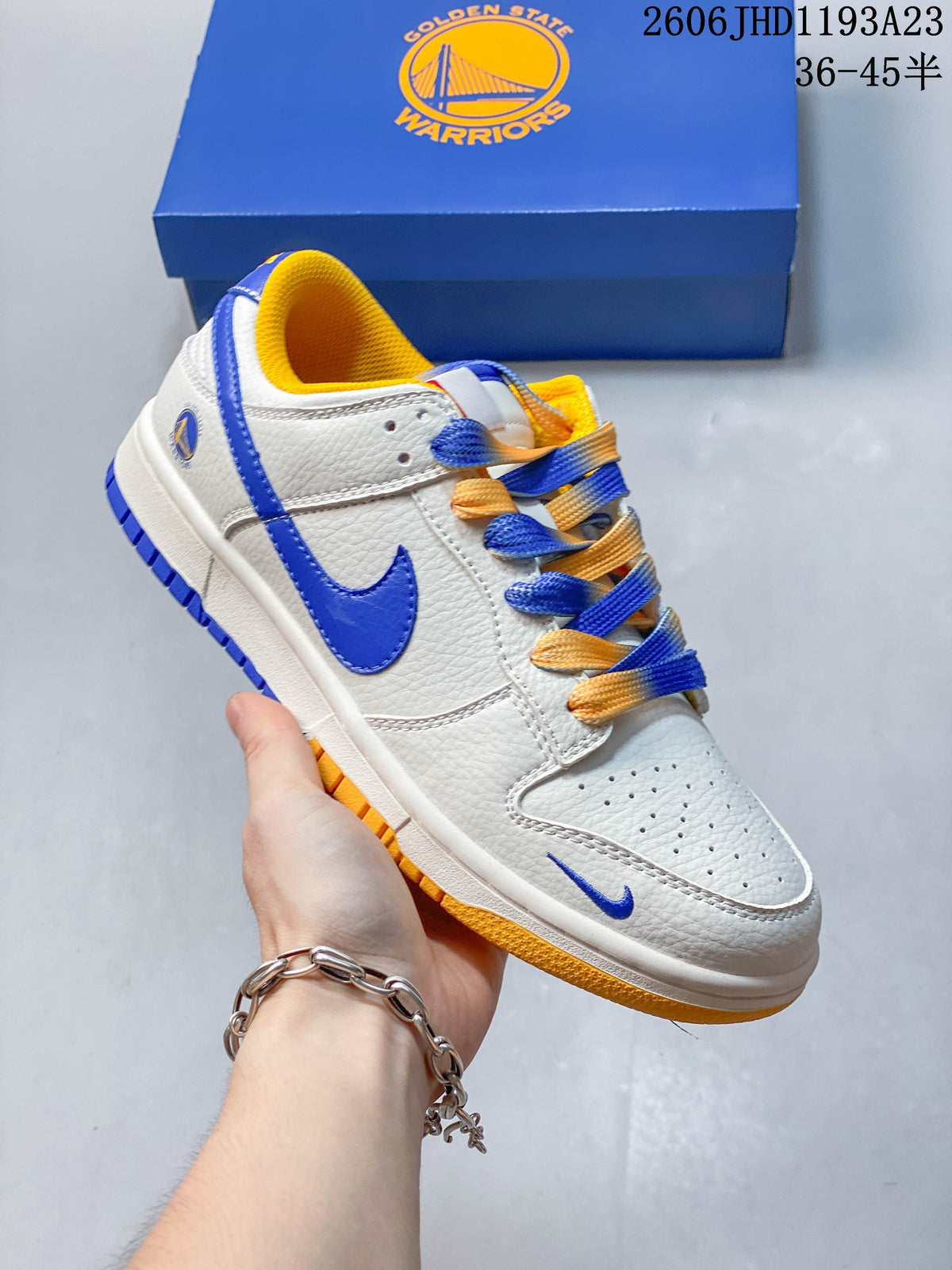 Side view of the sneaker with white upper, blue Swoosh, and yellow outsole