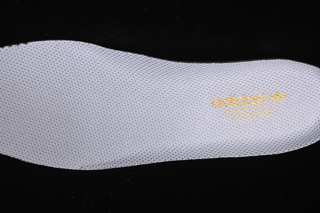 Close-up of the removable insole with gold adidas branding