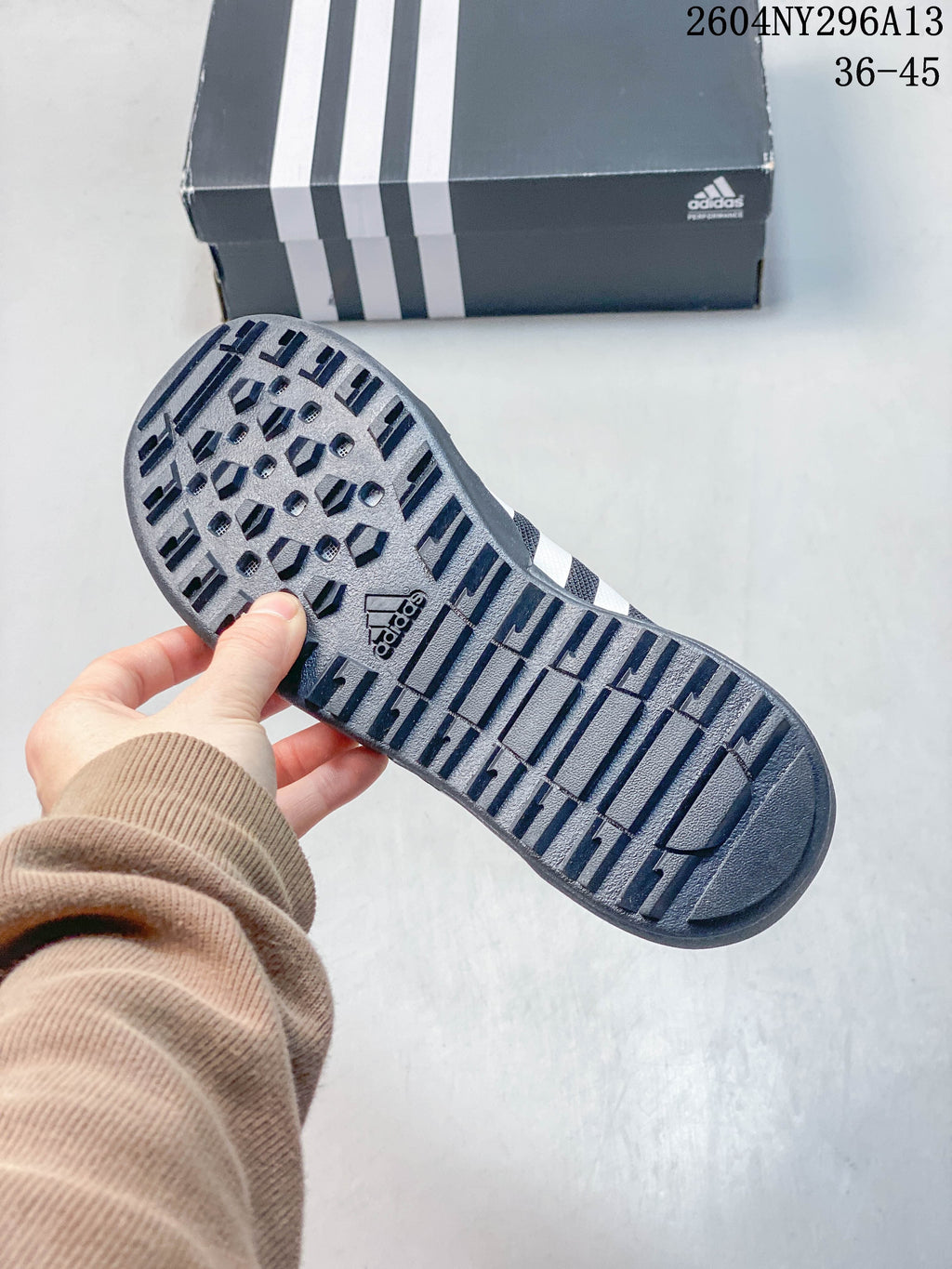 Close-up of the textured outsole on a dark grey adidas Terrex shoe