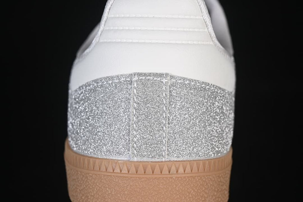 Rear view showing the silver glitter-effect heel panel, white heel detail and gum outsole.