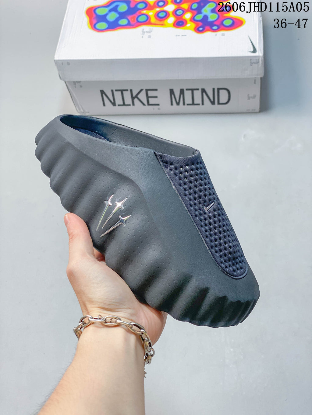 Dark gray Nike Mind slide with a perforated upper panel
