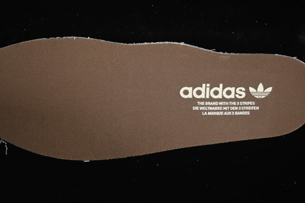 Brown adidas-branded insole shown separately