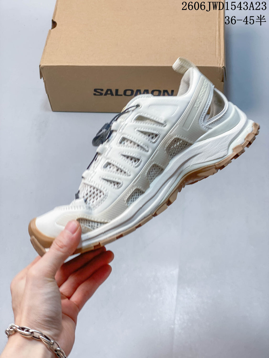 Side view of the off-white low-top shoe with mesh panels and quick laces