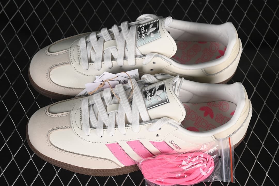 Pair of off-white and pink Samba OG sneakers with an additional set of pink laces
