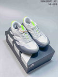 Pair of white and grey Adidas Adizero Evo SL running shoes with lime accents, shown on a shoebox.