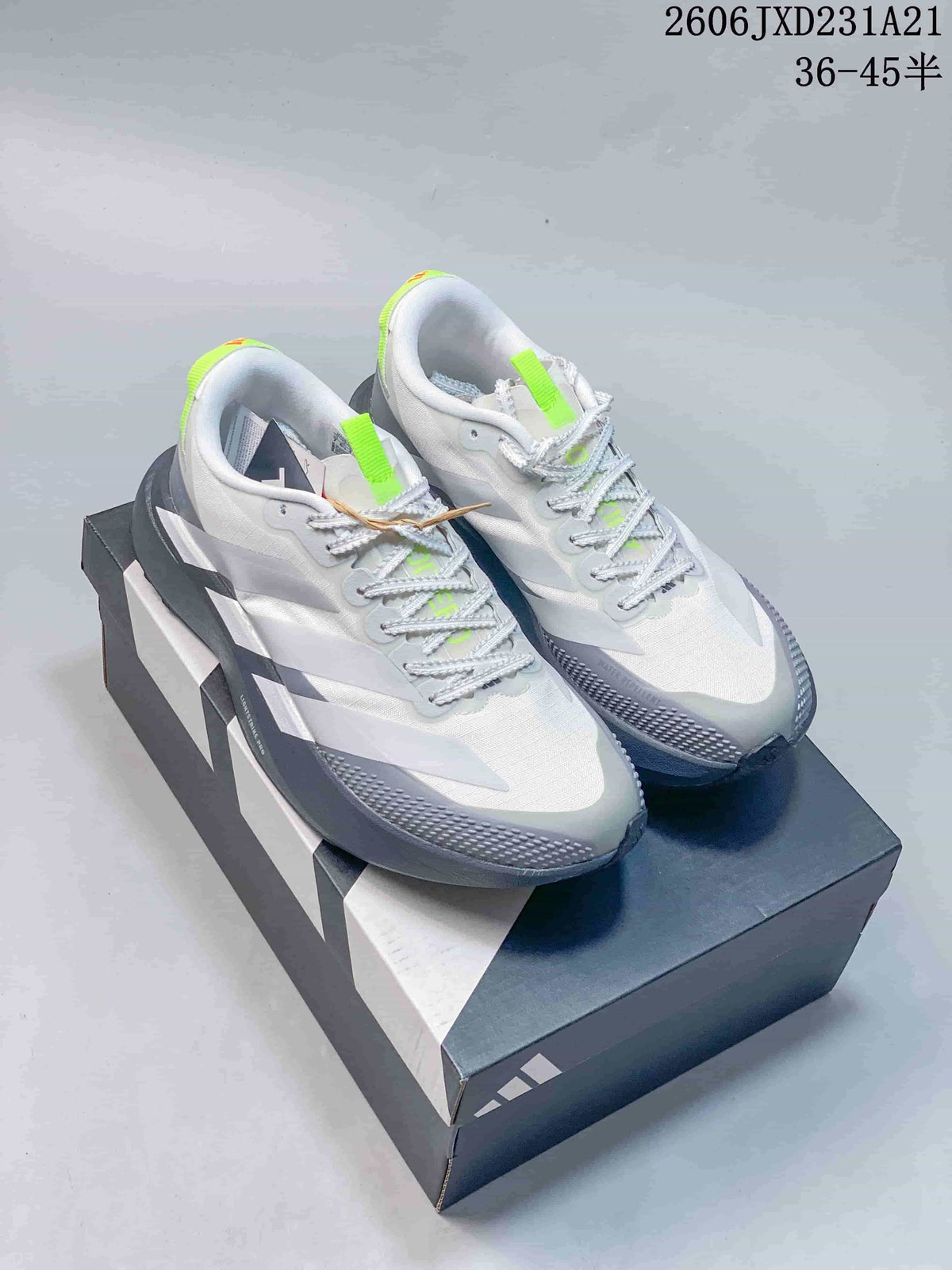 Pair of white and grey Adidas Adizero Evo SL running shoes with lime accents, shown on a shoebox.