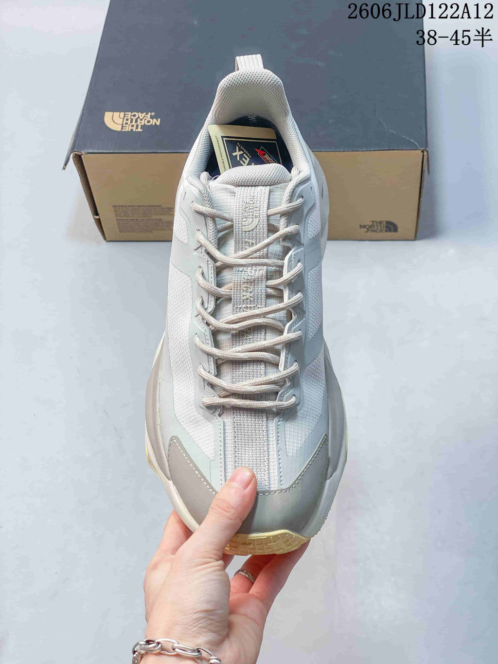 Top view of a gray hiking shoe showing its laces, tongue, and toe reinforcement.