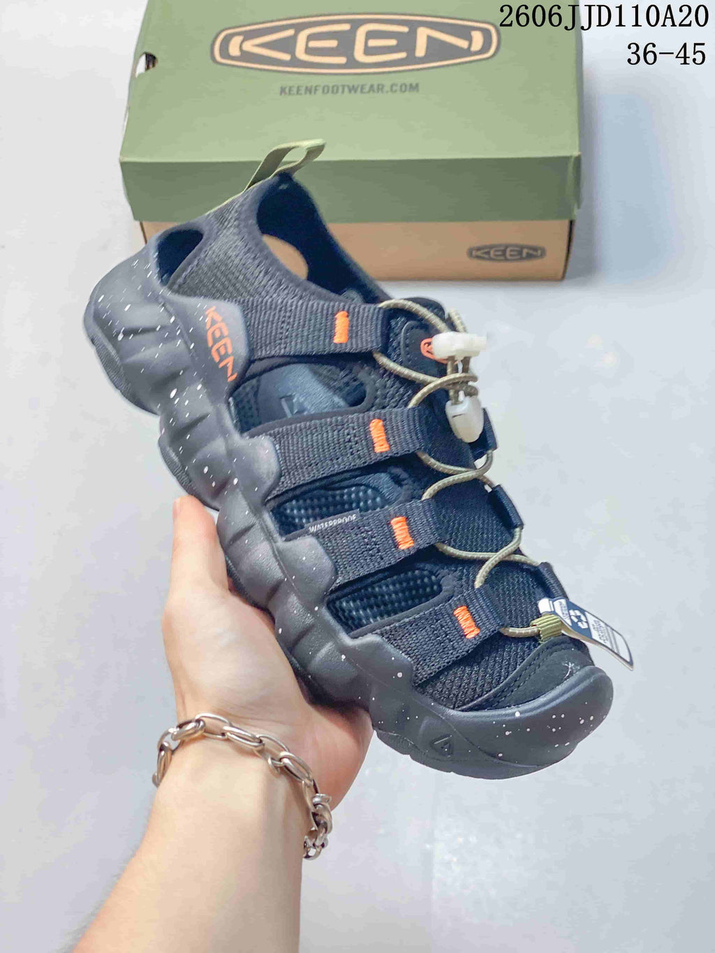 Angled view of the sandal showing the heel, side openings, and cord-and-toggle closure.