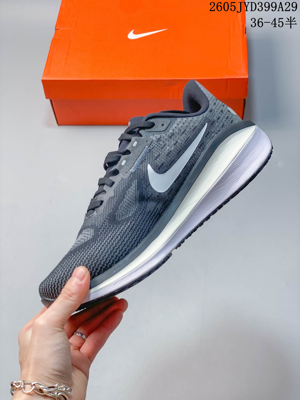 Side profile of the grey running shoe with white side detail