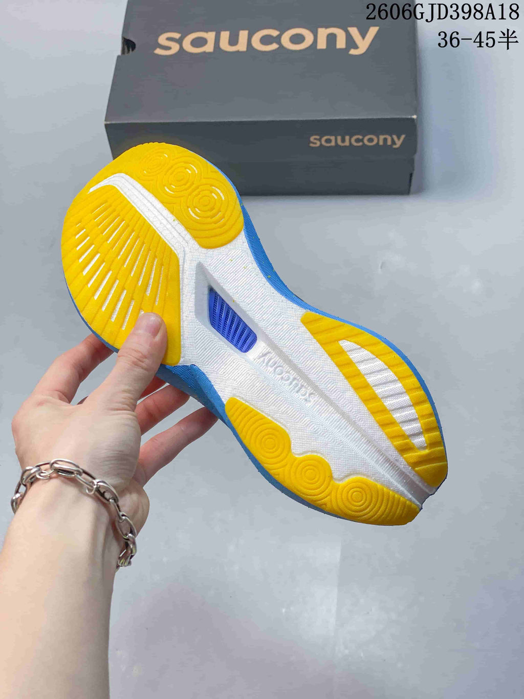 Underside view showing the yellow and white outsole with blue edges