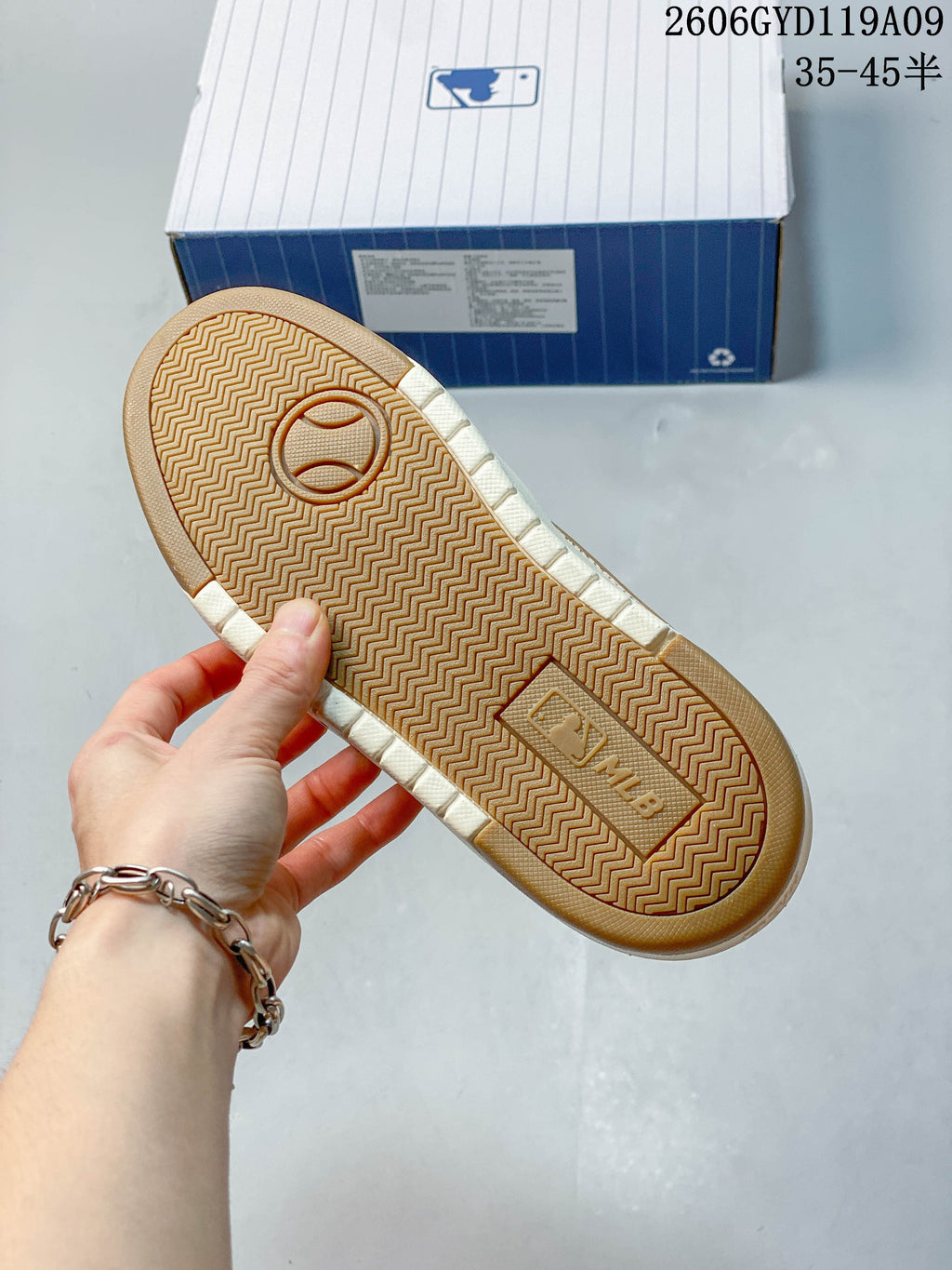 Underside of a sneaker showing a tan patterned outsole