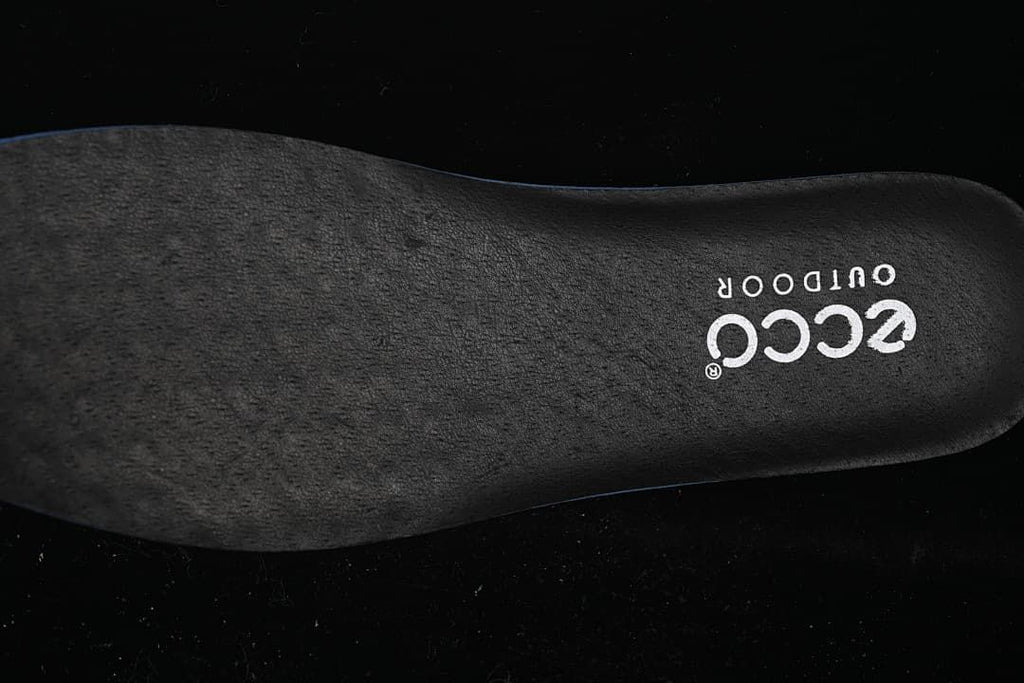 Close-up of a dark insole bearing ECCO OUTDOOR branding