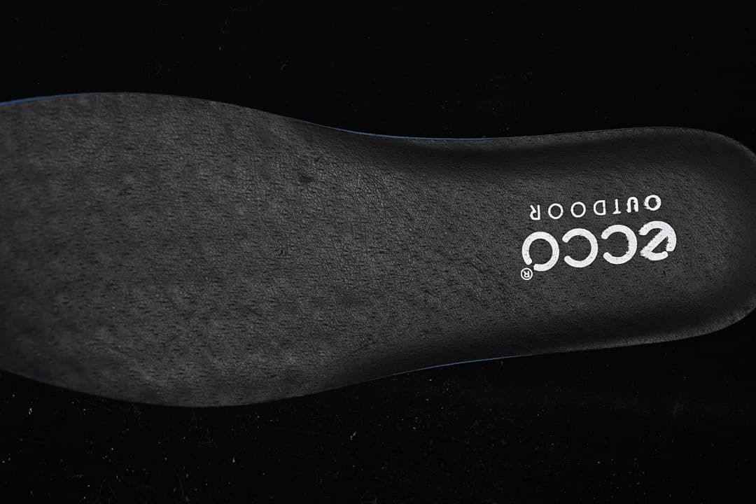 Close-up of a dark insole bearing ECCO OUTDOOR branding
