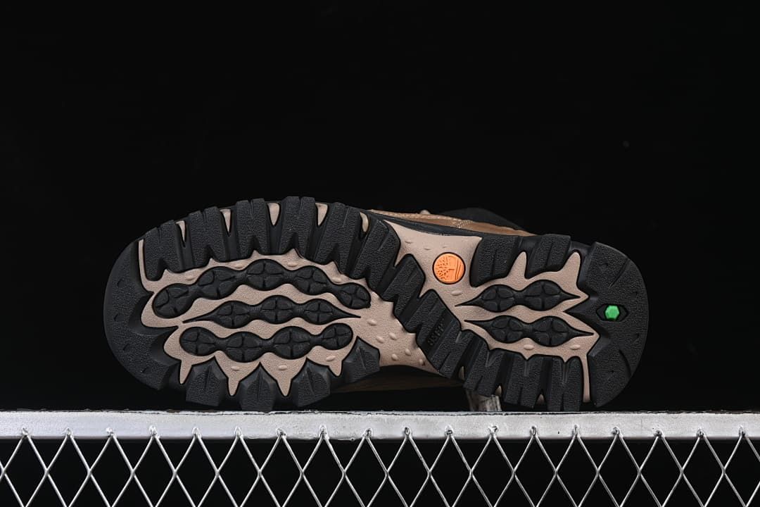 Underside view showing the boots' deeply lugged outsoles.