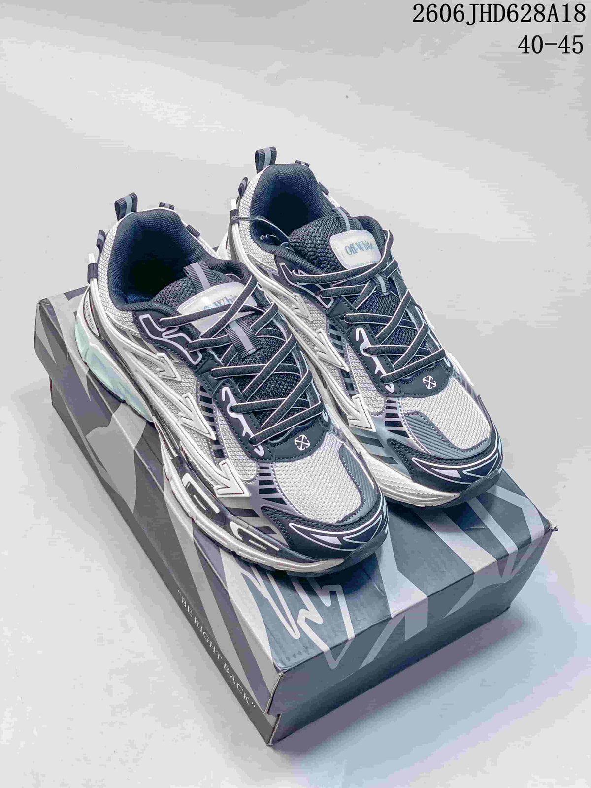 Pair of white and gray Off-White Be Right Back low-top sneakers shown on the box
