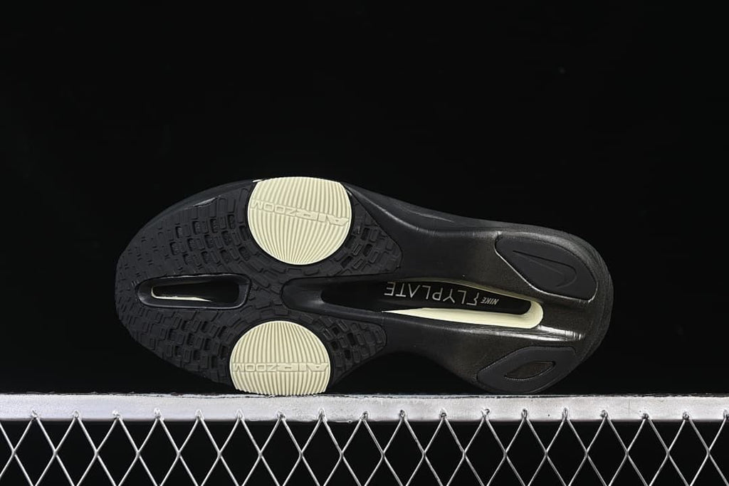Underside view showing the black outsole and pale yellow traction sections
