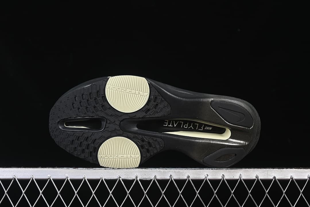 Underside view showing the black outsole and pale yellow traction sections