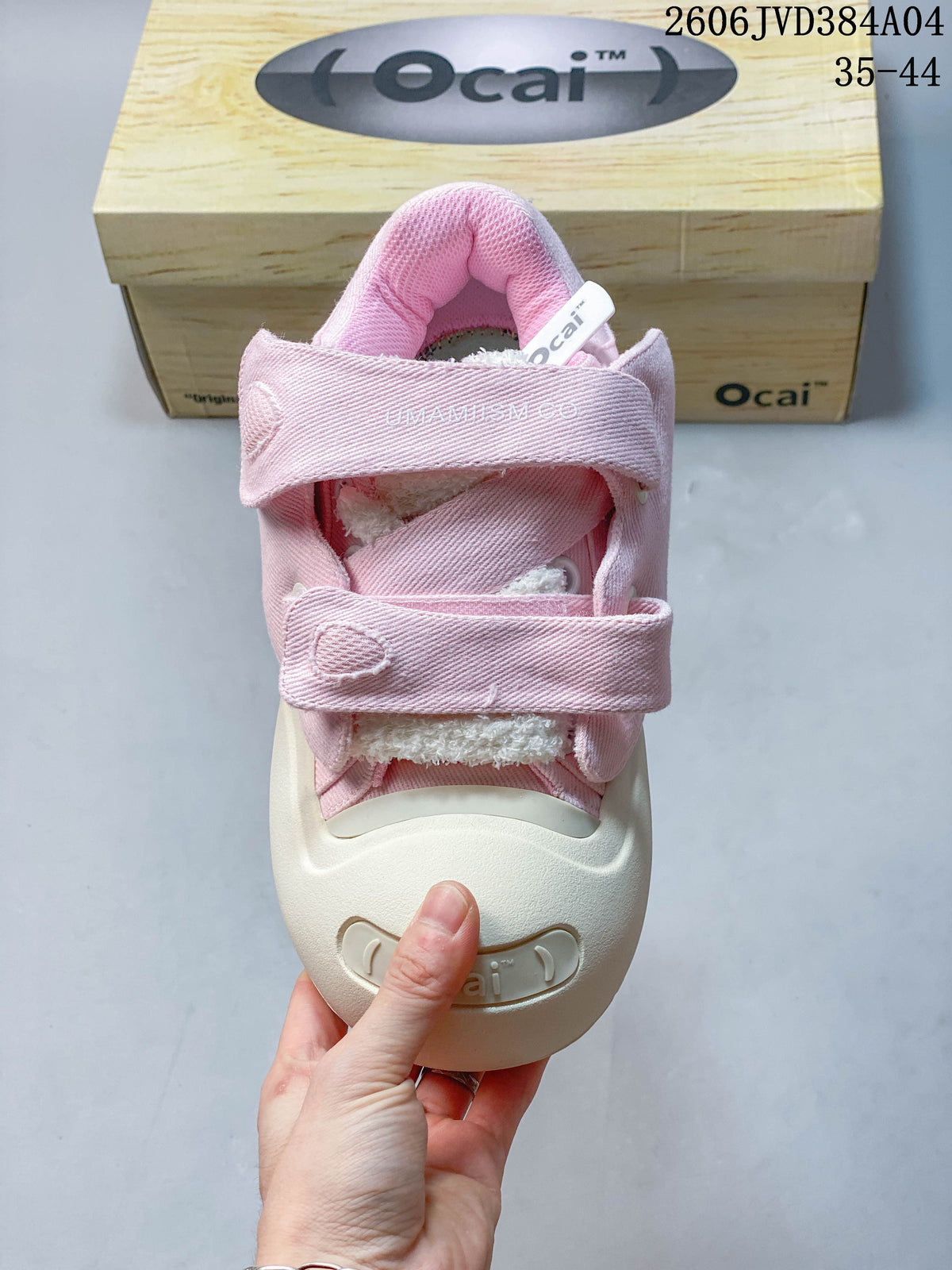 Top view of a pink sneaker showing its padded collar, layered straps, and plush-looking tongue detail.