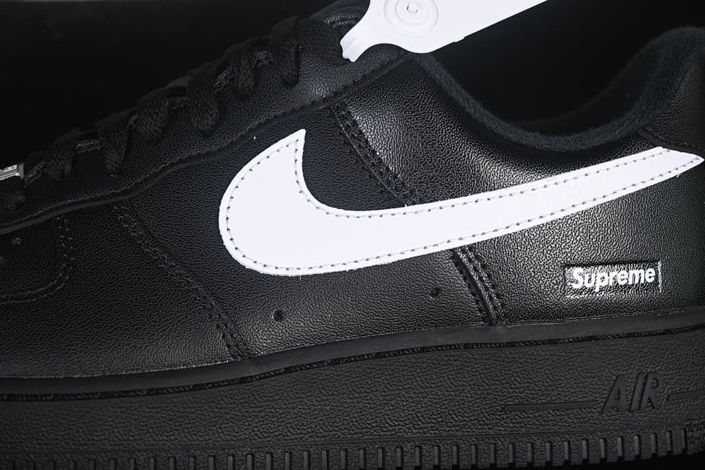 Close-up of the white Swoosh and Supreme heel-side detail