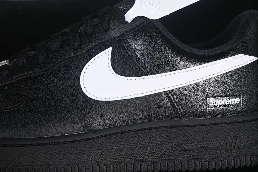 Close-up of the white Swoosh and Supreme heel-side detail