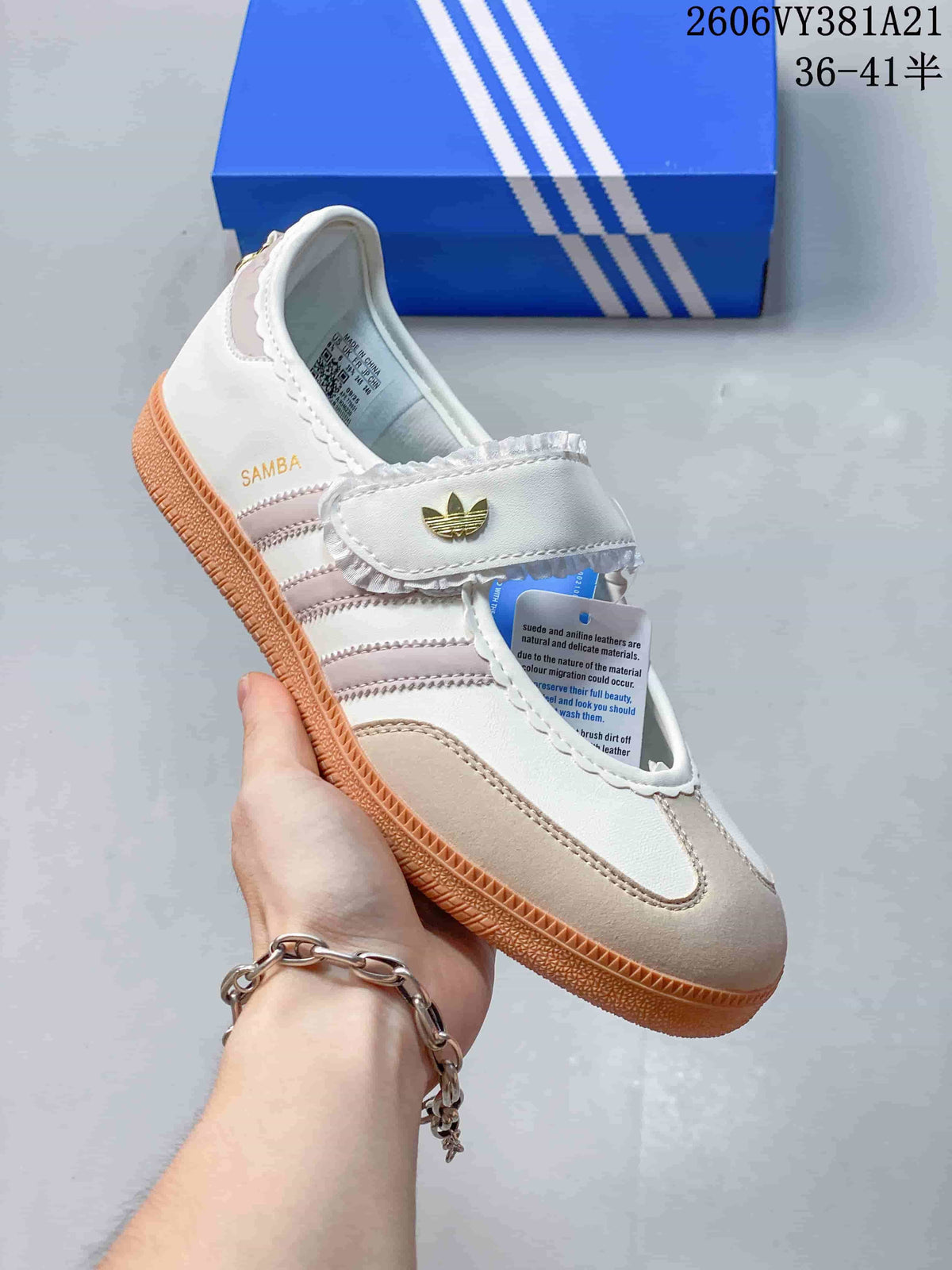 Angled view of the Samba Jane sneaker with its strap, pink accents, and gum sole