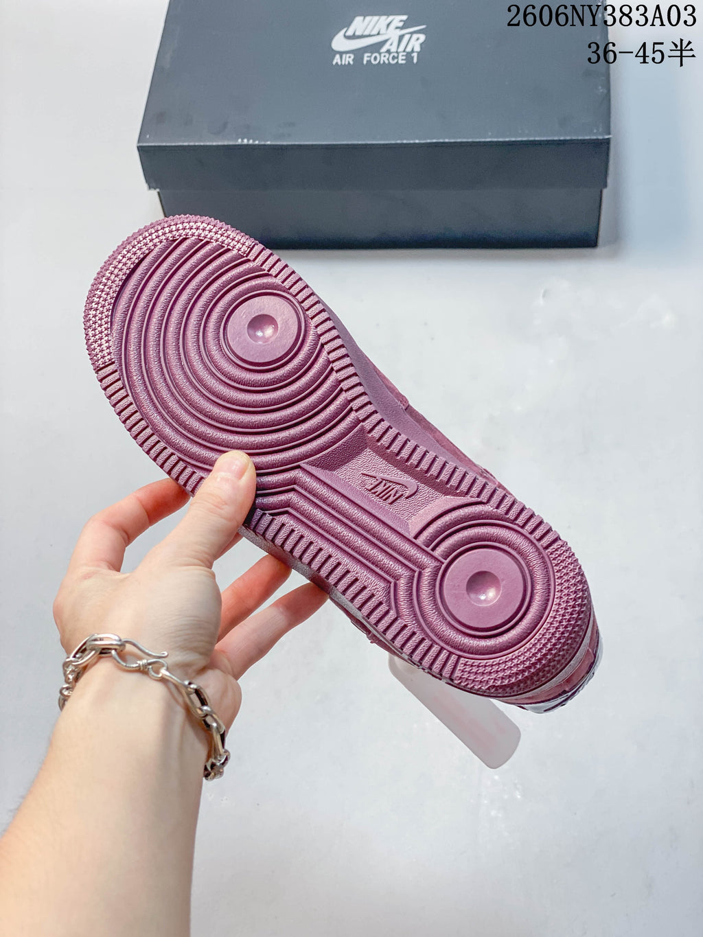 Close-up of the dusty rose sneaker outsole with circular tread