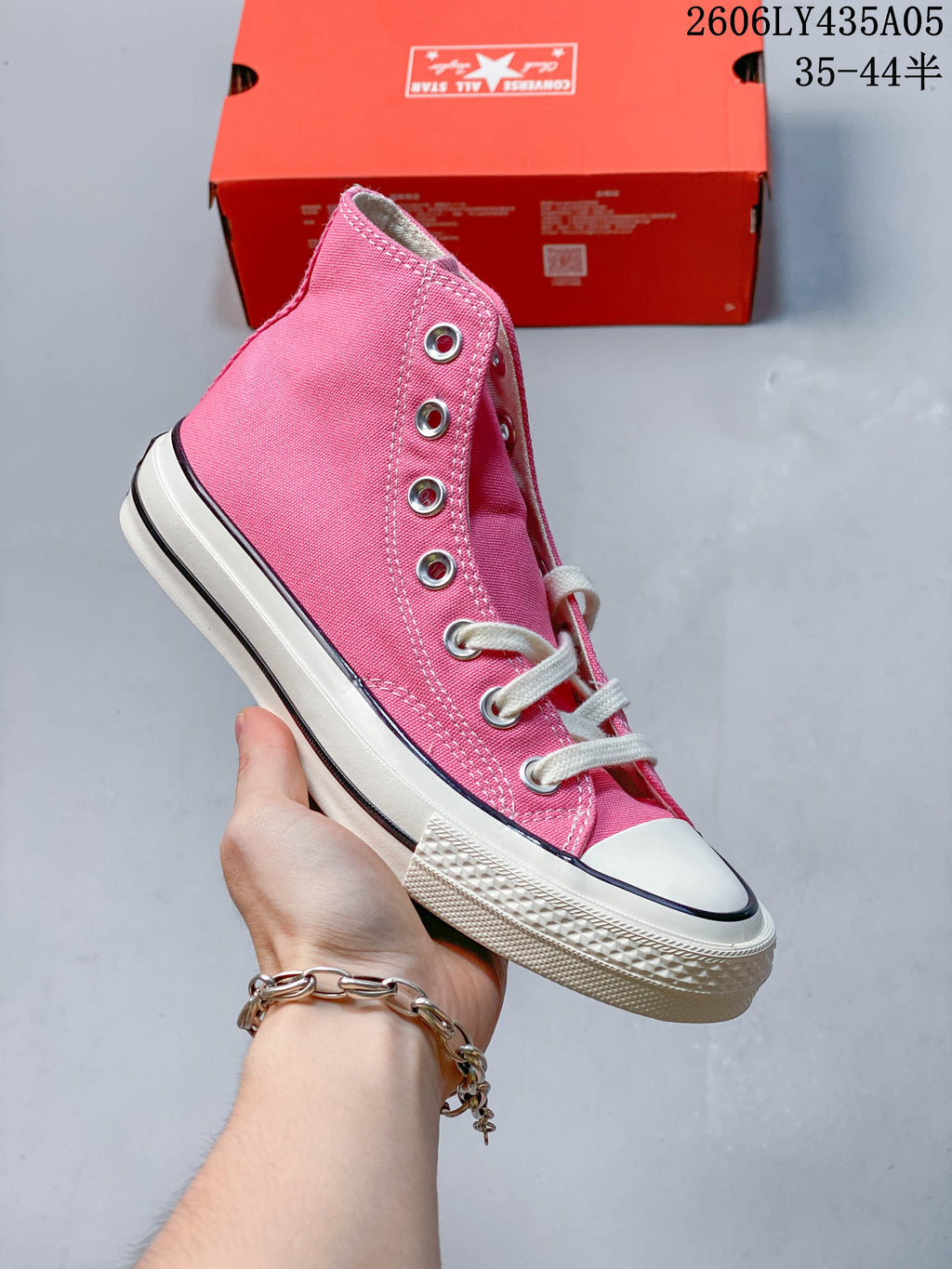 Side view of a pink Converse Chuck Taylor 1970s-style high-top sneaker