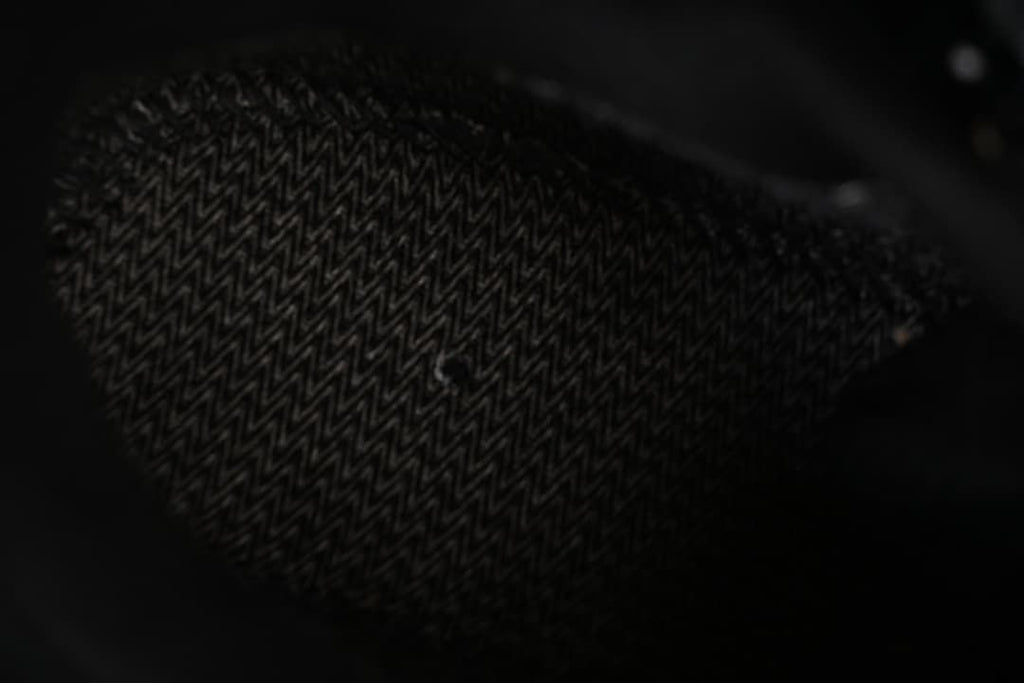 Close-up of patterned black shoe outsole tread.
