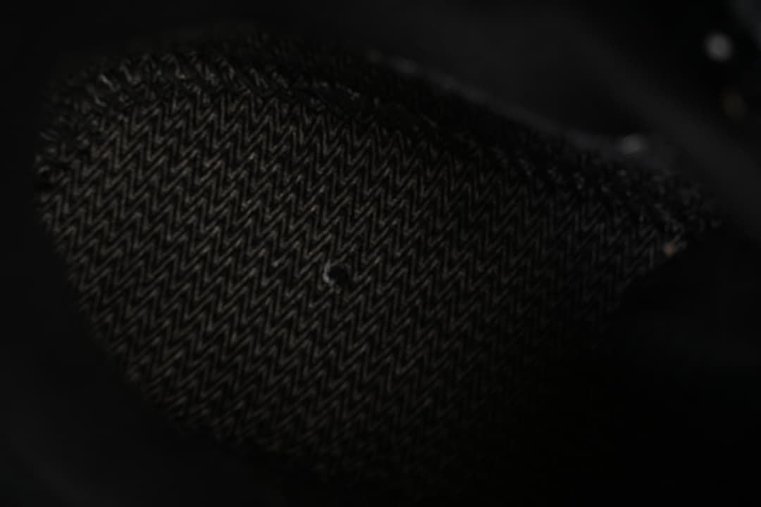 Close-up of patterned black shoe outsole tread.