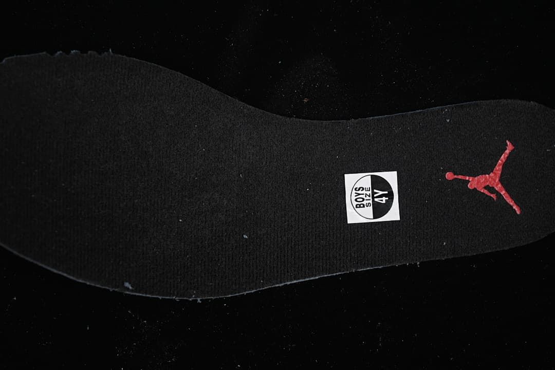 Black insole with a visible 4Y marking and red Jumpman logo.