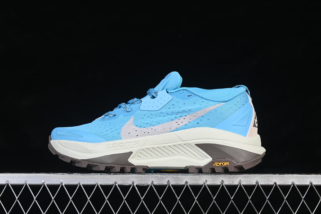 Opposite side view of a blue Nike ACG Zegama Trail shoe with a sculpted midsole and lugged outsole.