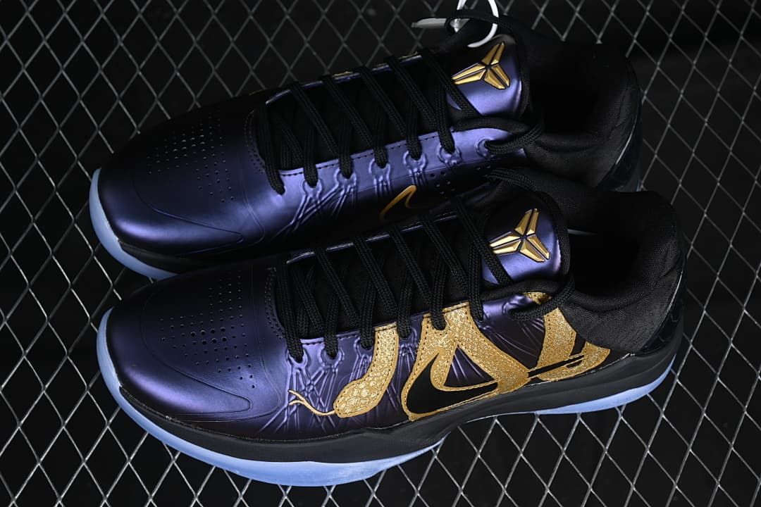 Pair of black, purple, and gold Kobe V Protro shoes viewed from above