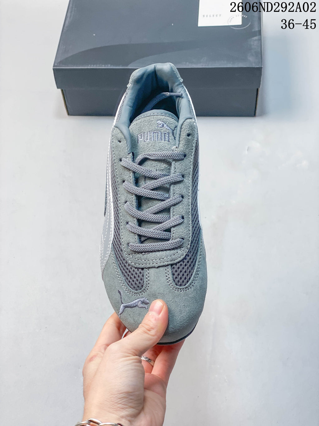 Top view of the lace-up front and mesh panels on a gray Puma sneaker
