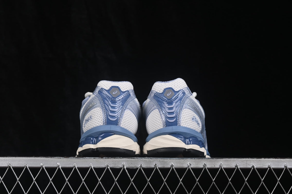 Rear view of a pair of ASICS sneakers showing the padded collars, blue heel structures, and contrasting outsole sections.