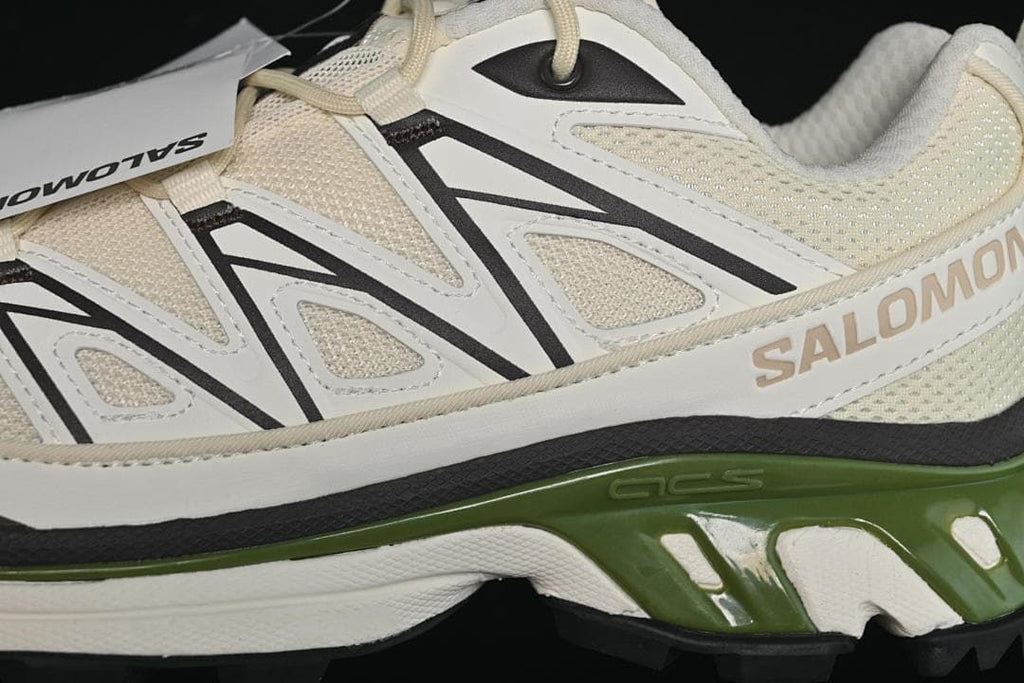 Close-up of the mesh upper, side overlays, Salomon branding, and green midsole.