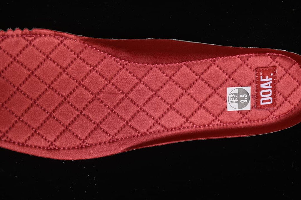 Close-up of a red quilted insole showing a size 9.5 label.