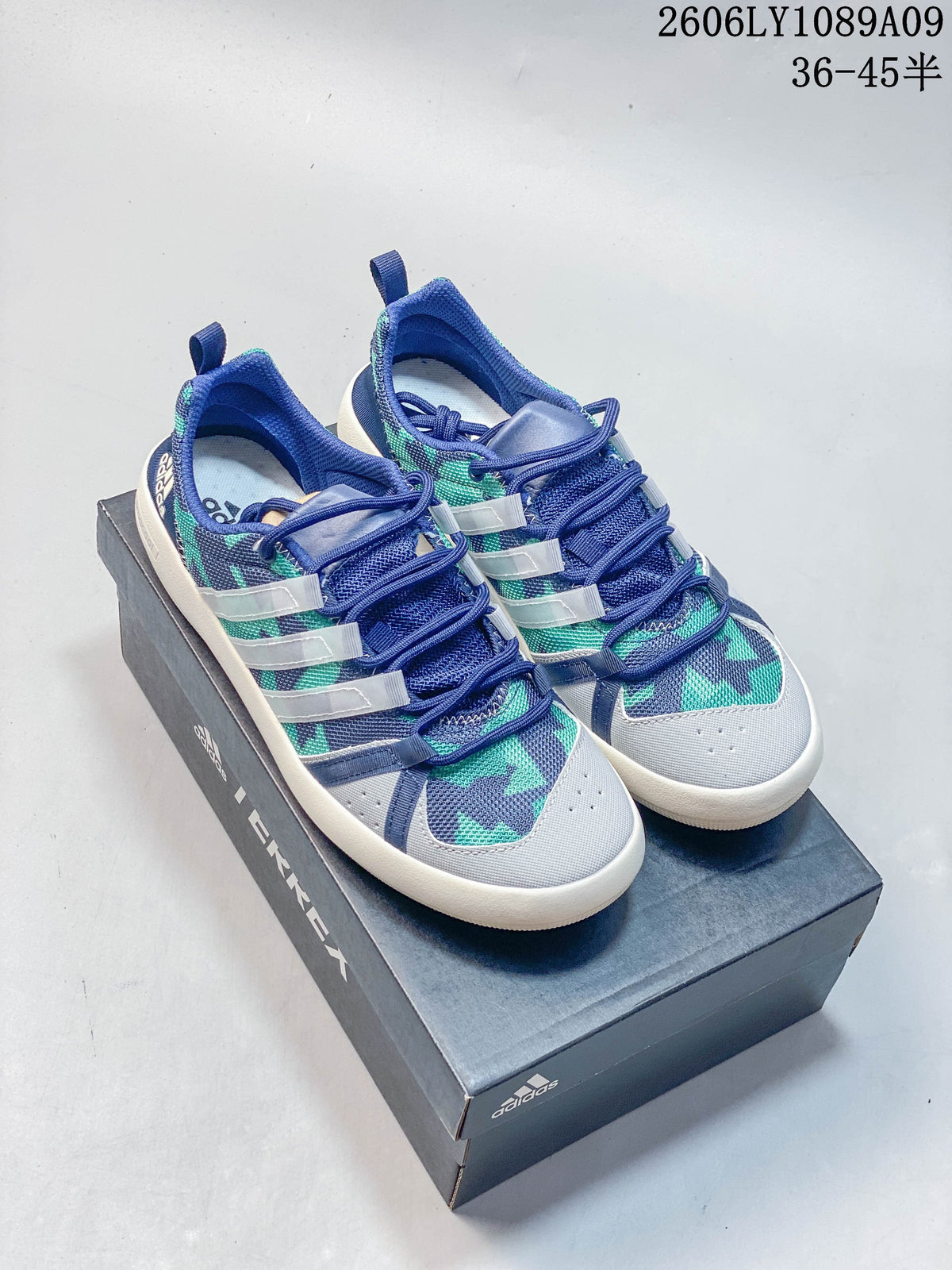Pair of blue, gray, and teal graphic Adidas Climacool shoes with light-colored side stripes.