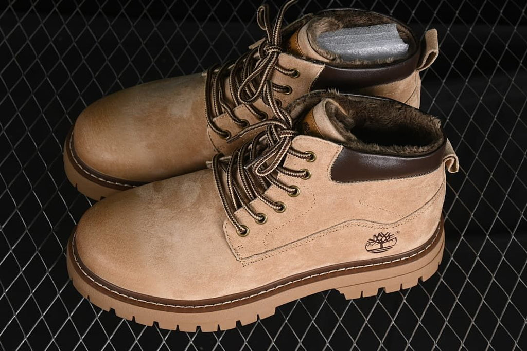Pair of beige lined lace-up ankle boots with chunky soles