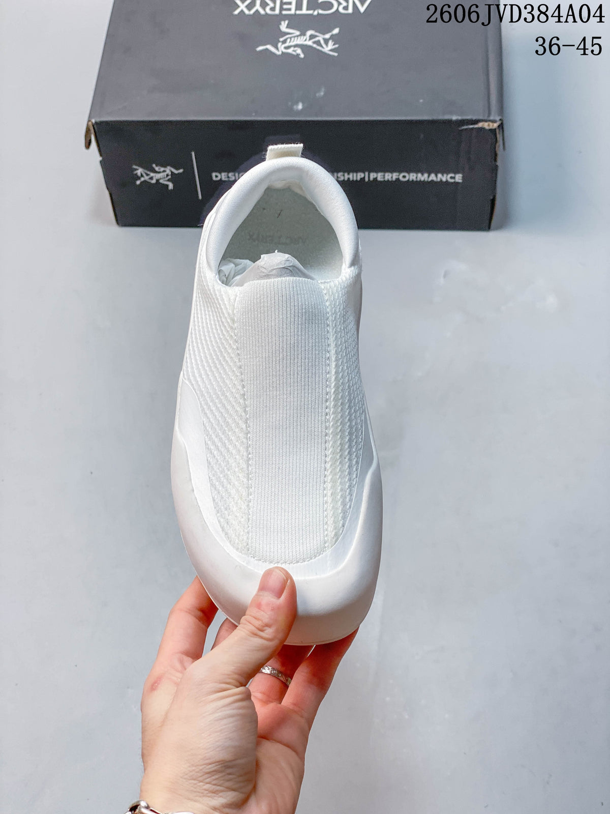 Front view of the white shoe showing its sock-like upper
