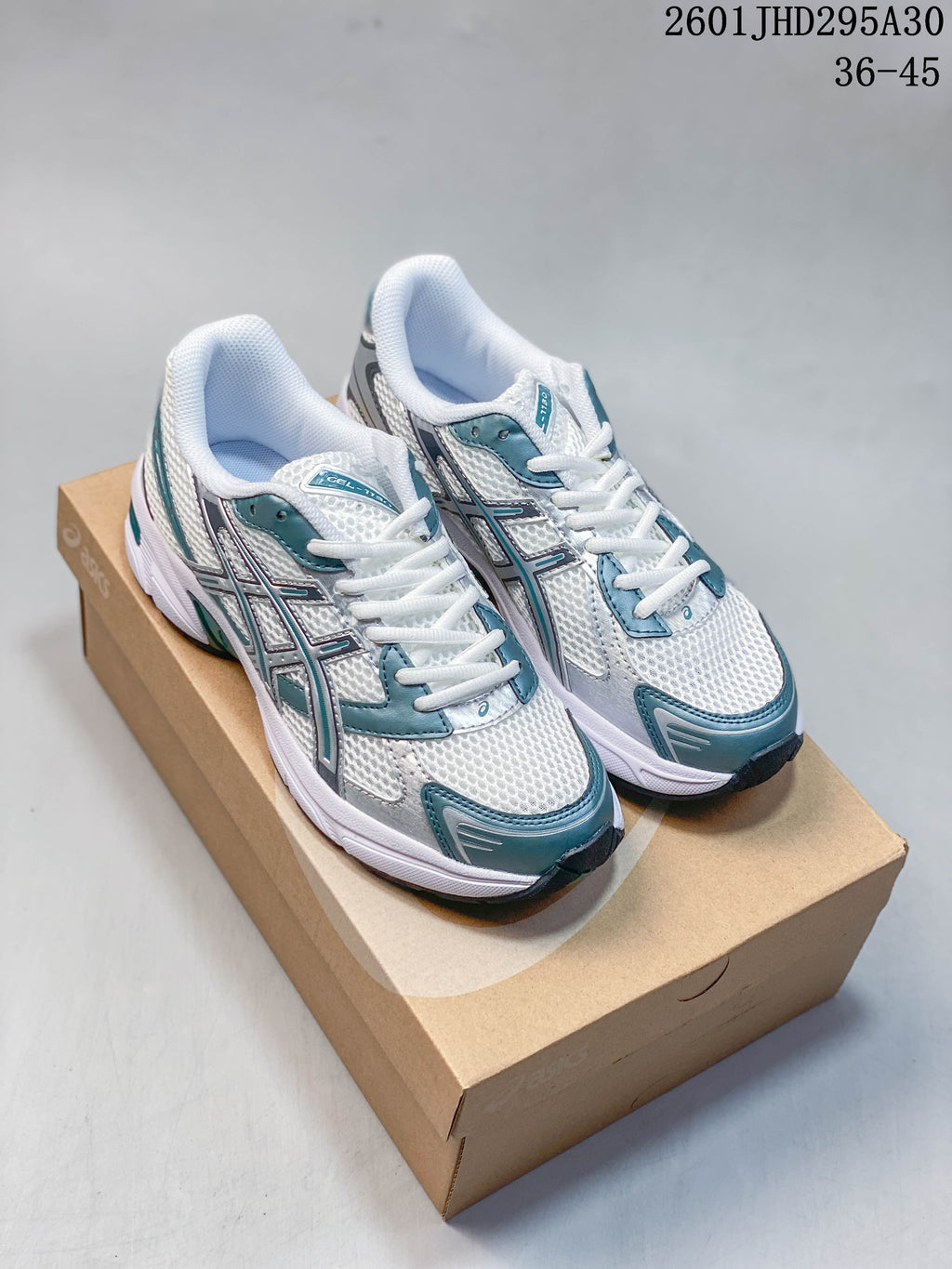 Pair of white ASICS GEL-Nimbus 10.1 sneakers with silver and teal accents