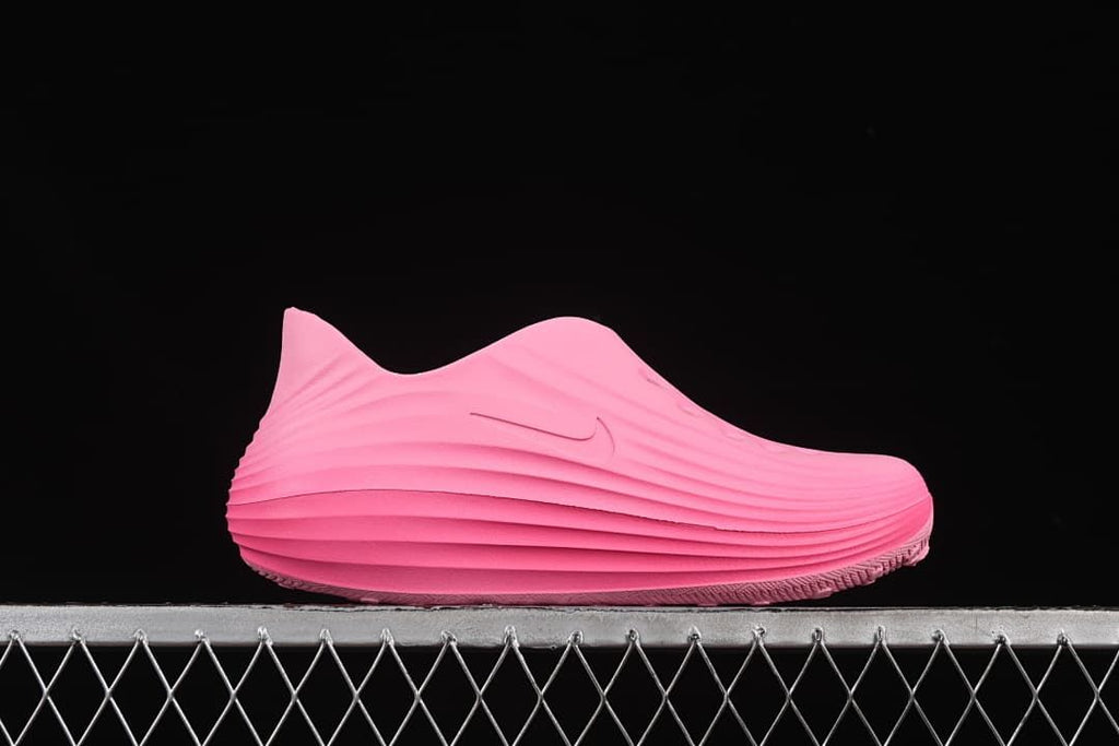 Side view of the pink slip-on clog with sculpted ridges.