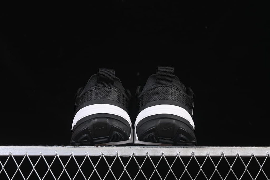 Rear view of both shoes showing their heel panels and soles.