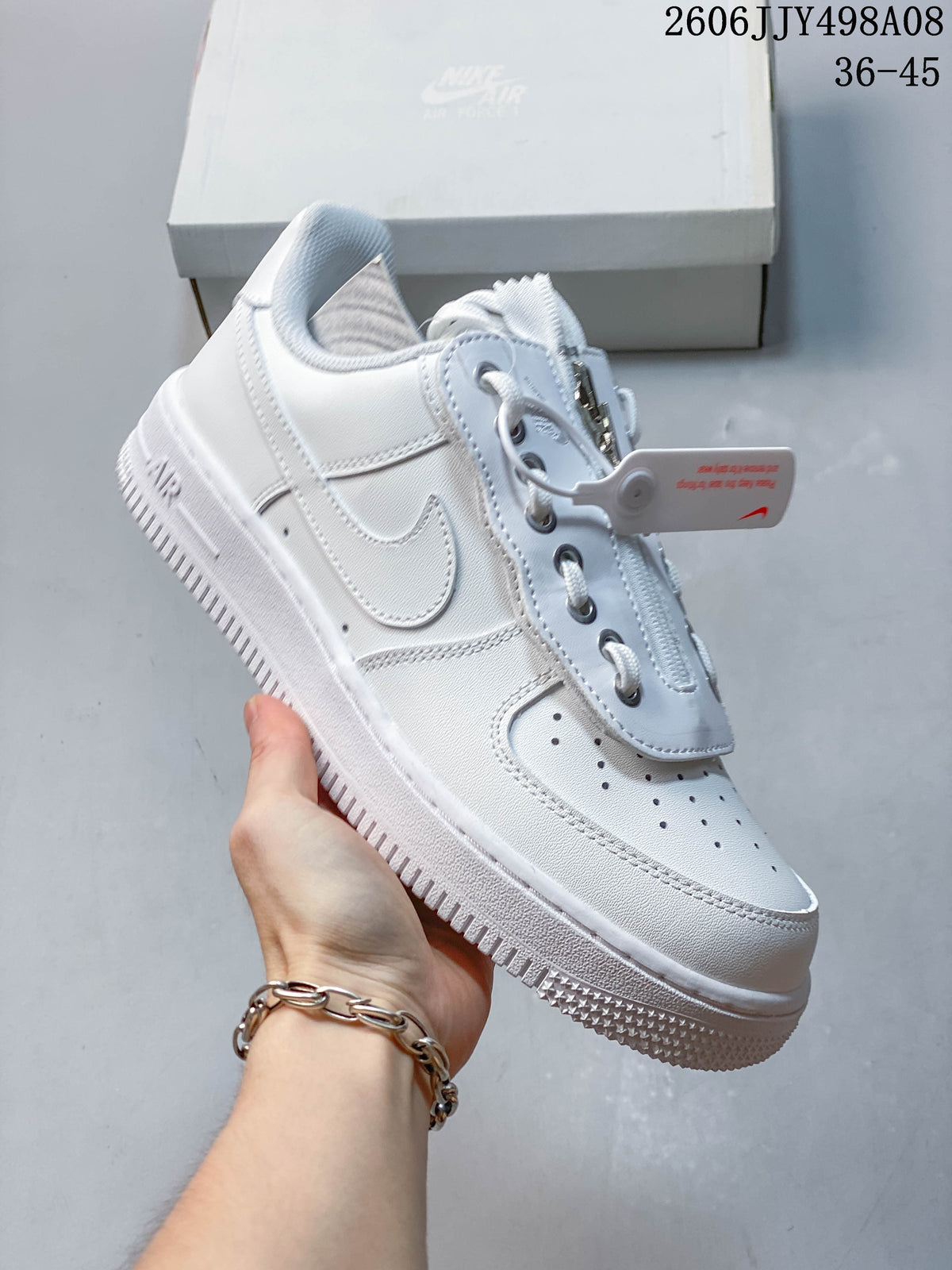 Side view of a white Nike Air Force 1 ’07 Low sneaker showing the Swoosh, chunky sole, and zip-detail lace cover.