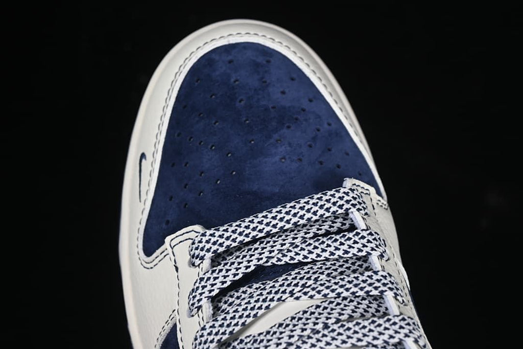 Top view of a navy perforated toe and patterned laces.