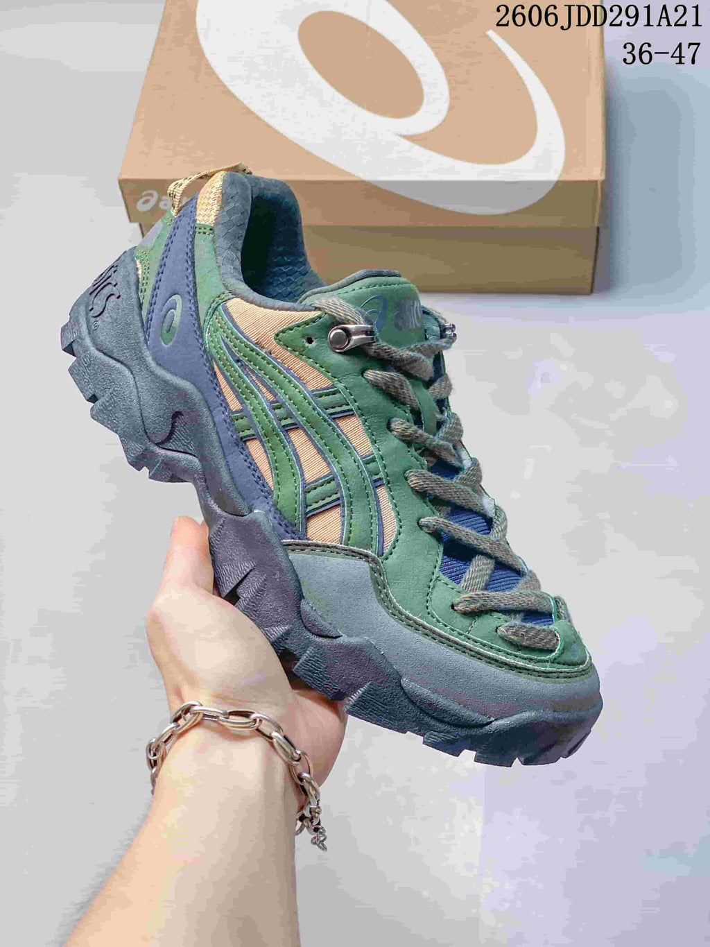 Green, blue, and tan ASICS GEL-PICKAX sneaker with a chunky outsole.